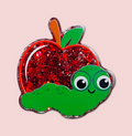 Apple and worm interchangeable badge topper with a red glitter apple