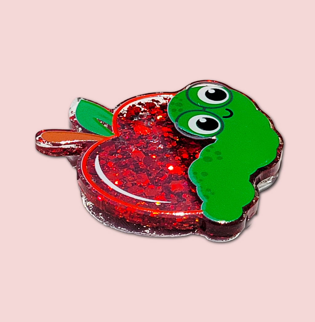 Side view of the apple and worm interchangeable badge topper