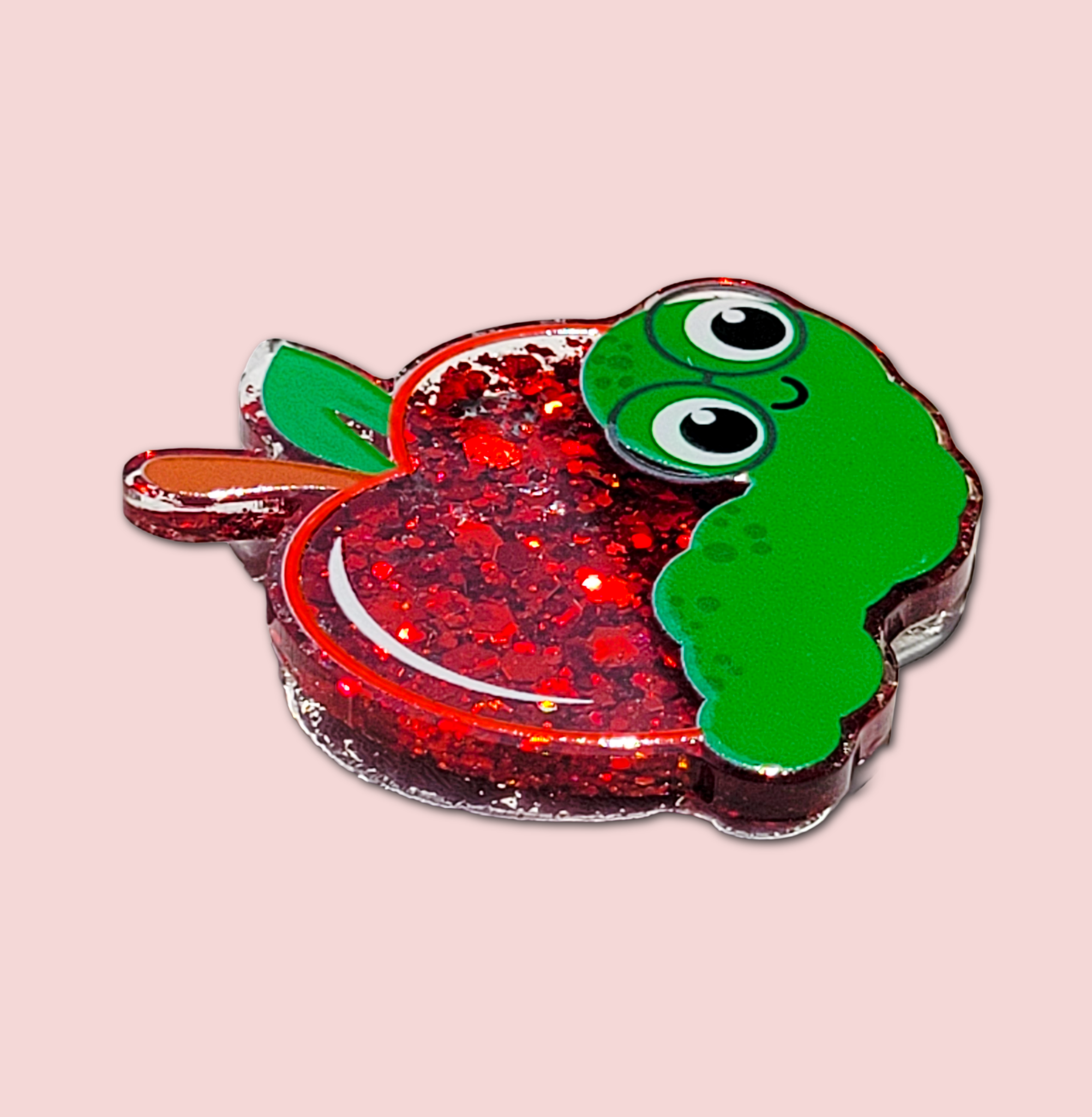 Side view of the apple and worm interchangeable badge topper