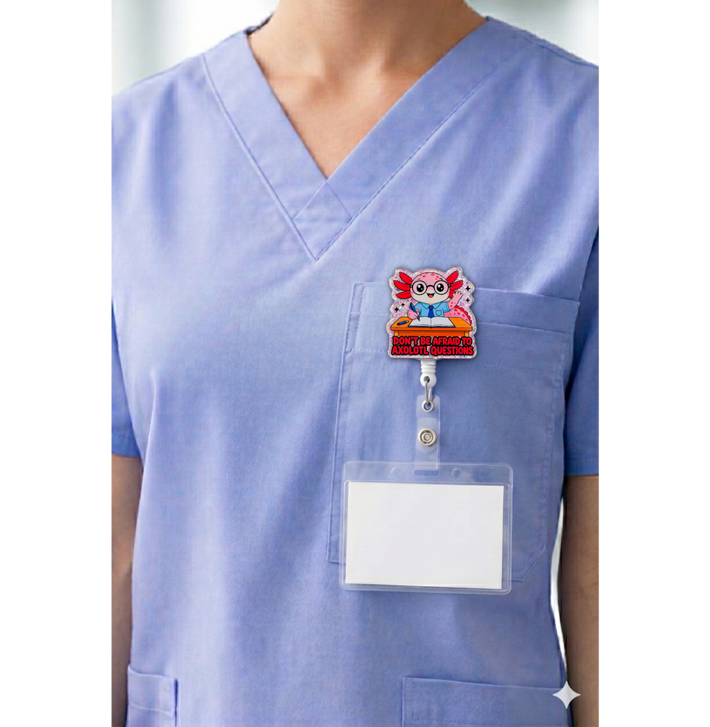 Axolotl questions teacher interchangeable badge topper shown on blue scrubs