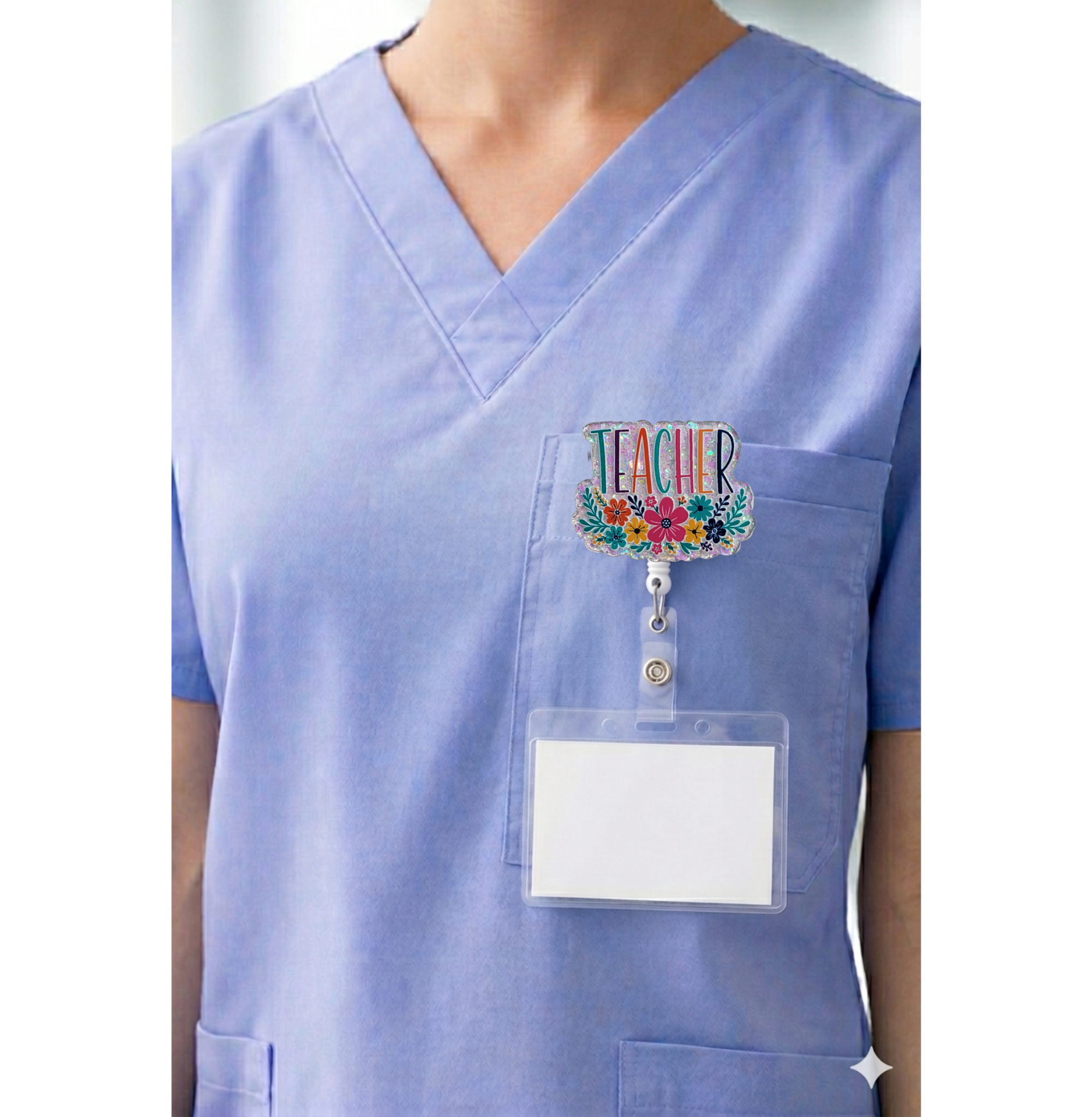 Floral teacher interchangeable badge topper shown on blue scrubs